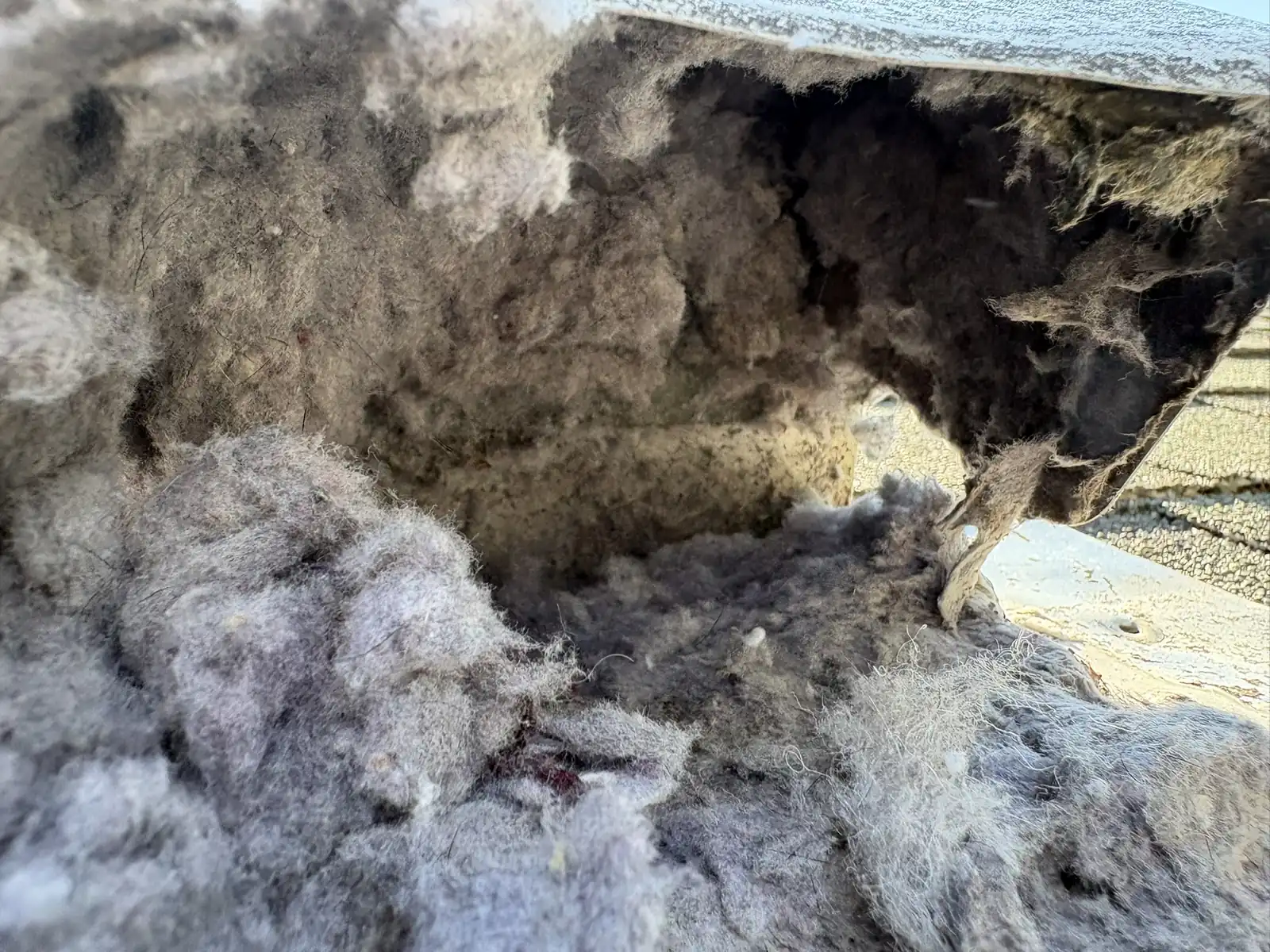 Compacted lint packed inside a dryer duct