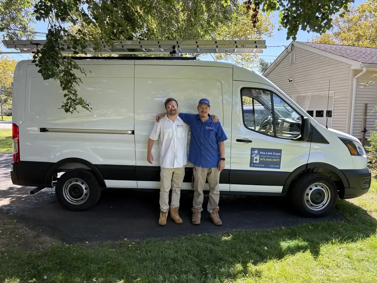 The Lint Guys team beside the service van in a driveway