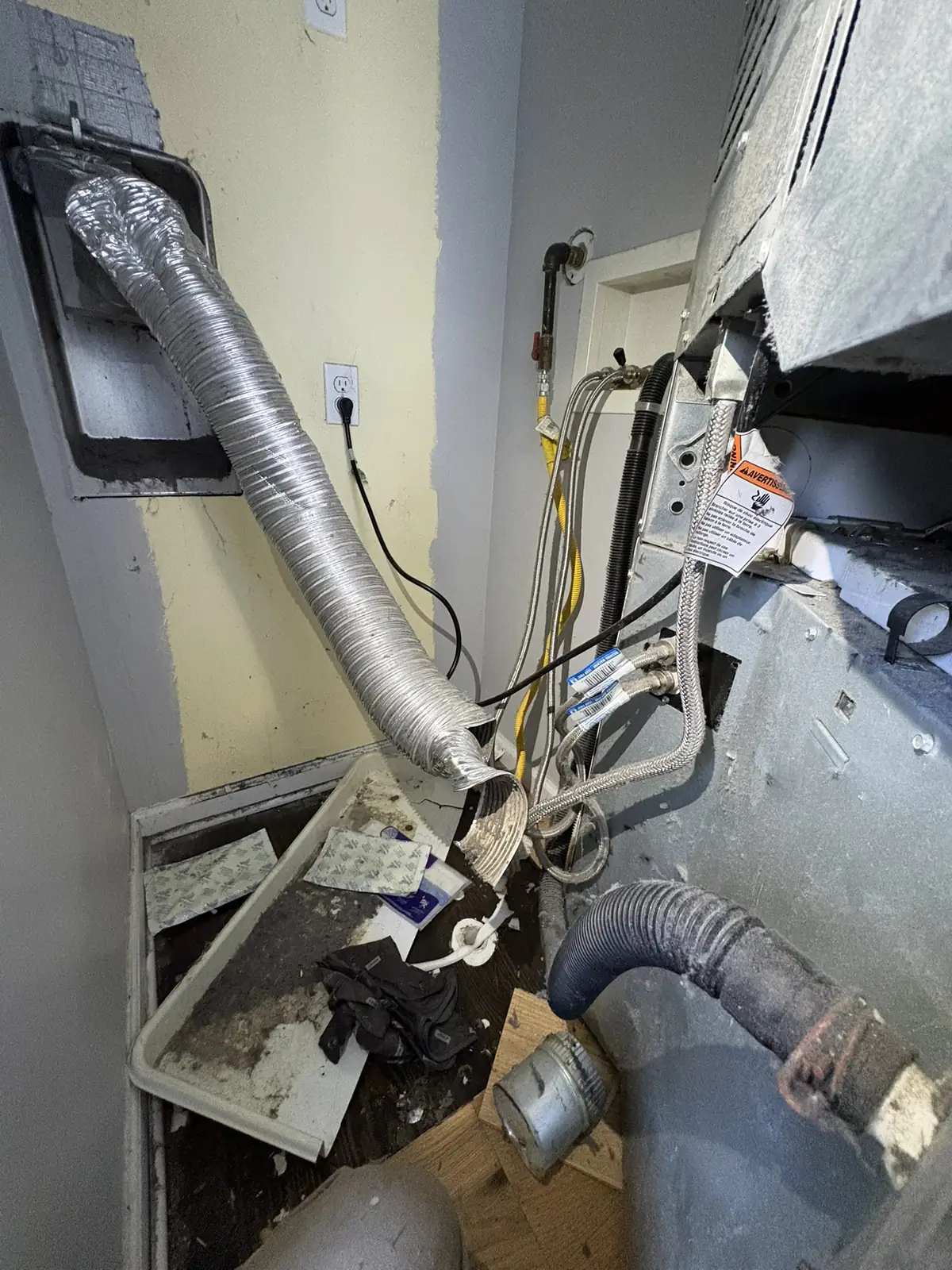 Semi-rigid aluminum transition hose connected behind a dryer