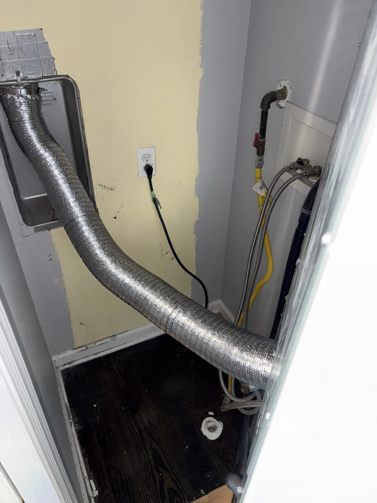 Semi-rigid aluminum transition hose running from the dryer to the wall duct